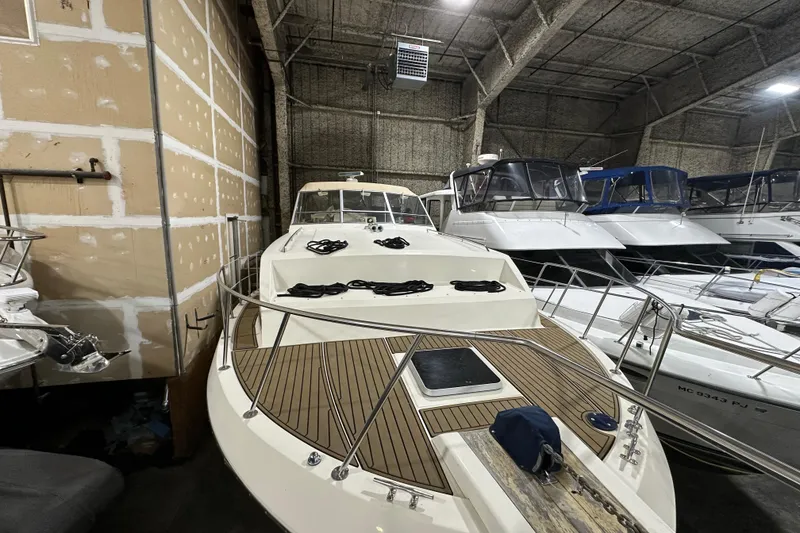 Slide: The Image of 1986 Chris-Craft 381 Catalina yacht in storage, showcasing sleek design and spacious deck. - 2
