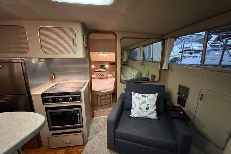 Slide: The Image of 1986 Chris-Craft 381 Catalina interior with kitchen, seating, and bedroom view. - 20