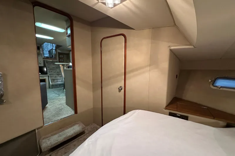 Slide: The Image of 1986 Chris-Craft 381 Catalina interior cabin with bed, mirror, and window. - 23