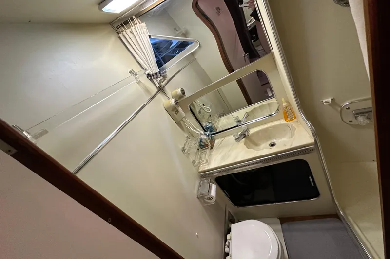 Slide: The Image of 1986 Chris-Craft 381 Catalina bathroom with sink, mirror, and toilet. - 24