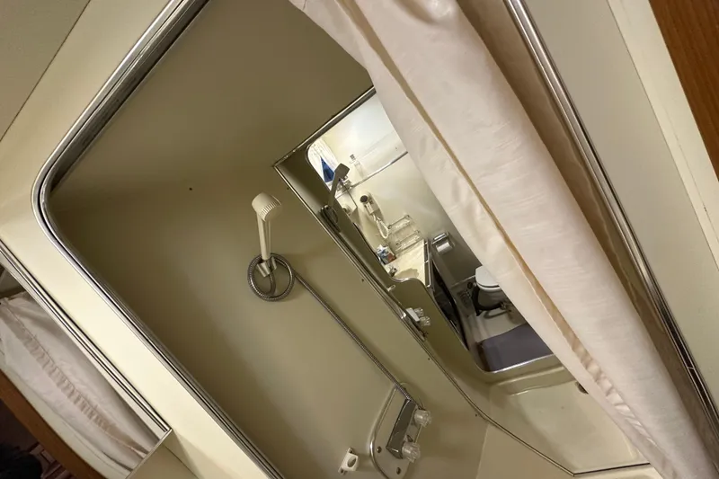 Slide: The Image of 1986 Chris-Craft 381 Catalina bathroom with shower, curtain, and toilet. - 25