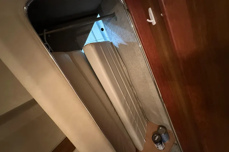 Slide: The Image of 1986 Chris-Craft 381 Catalina interior storage with cushions and paint cans. - 26