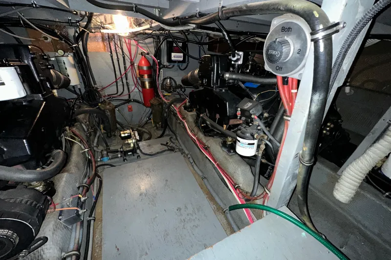 Slide: The Image of Engine room of 1986 Chris-Craft 381 Catalina, showcasing mechanical components and wiring. - 27