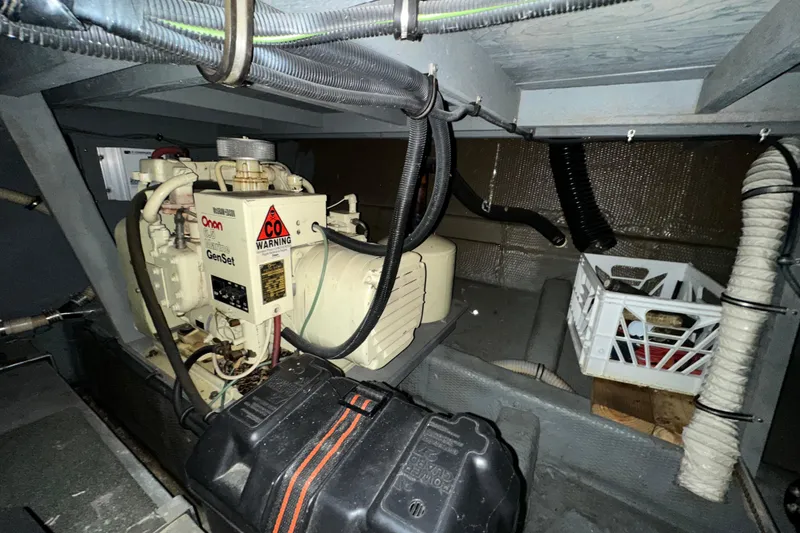 Slide: The Image of Engine room of 1986 Chris-Craft 381 Catalina with Onan generator and storage crate. - 29