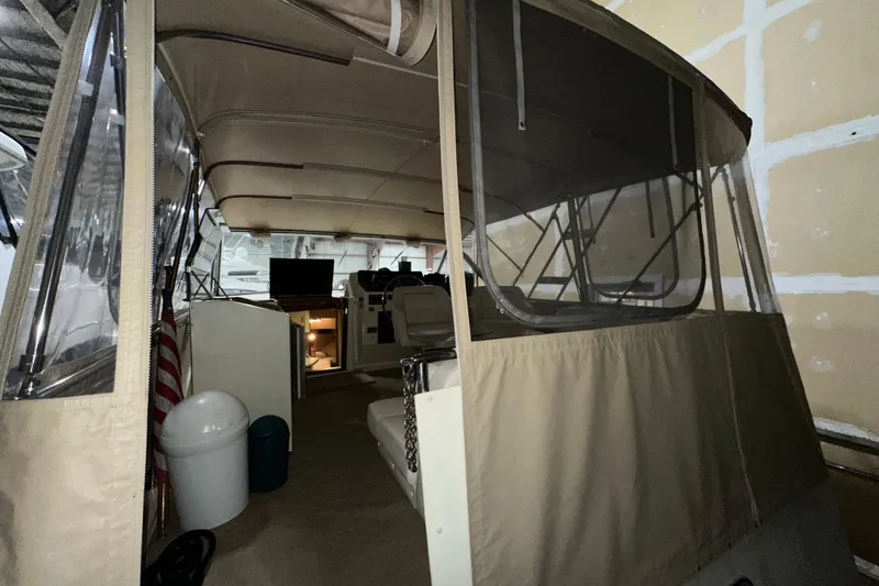Slide: The Image of 1986 Chris-Craft 381 Catalina interior with covered seating and helm, showcasing classic design. - 3