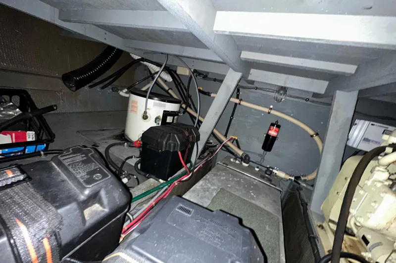 Slide: The Image of Engine room of 1986 Chris-Craft 381 Catalina, showcasing wiring and mechanical components. - 30