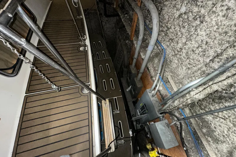 Slide: The Image of 1986 Chris-Craft 381 Catalina boat deck with metal railings and electrical wiring. - 5