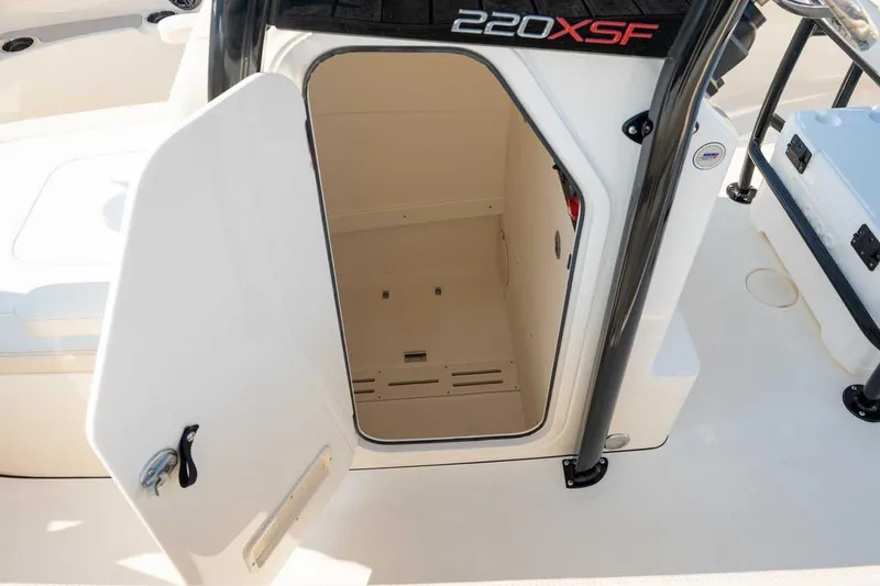 Slide: The Image of Open storage compartment on 2026 Scout 220 XSF boat, showcasing interior space. - 10