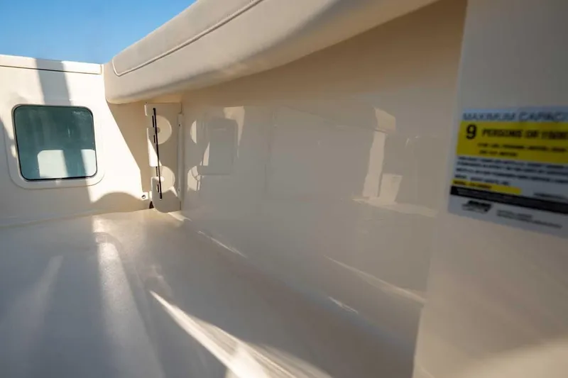 Slide: The Image of Interior view of 2026 Scout 220 XSF boat, showcasing seating and capacity label. - 13