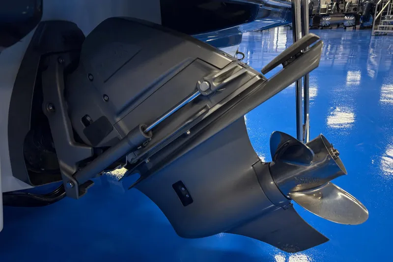Slide: The Image of Close-up of a 2012 Chaparral 226 SSi boat propeller on a glossy blue floor. - 10