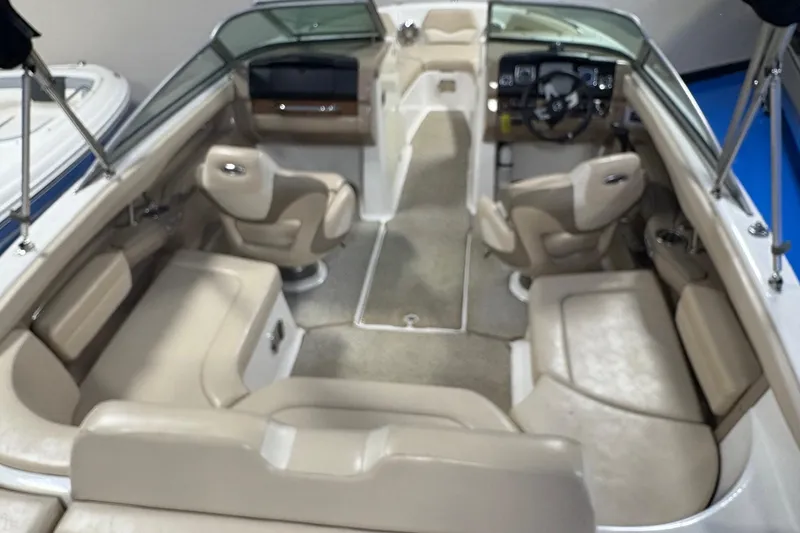 Slide: The Image of Interior of a 2012 Chaparral 226 SSi boat with beige seating and steering console. - 3