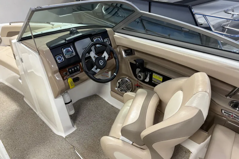 Slide: The Image of Interior view of 2012 Chaparral 226 SSi boat cockpit with steering wheel and dashboard. - 5
