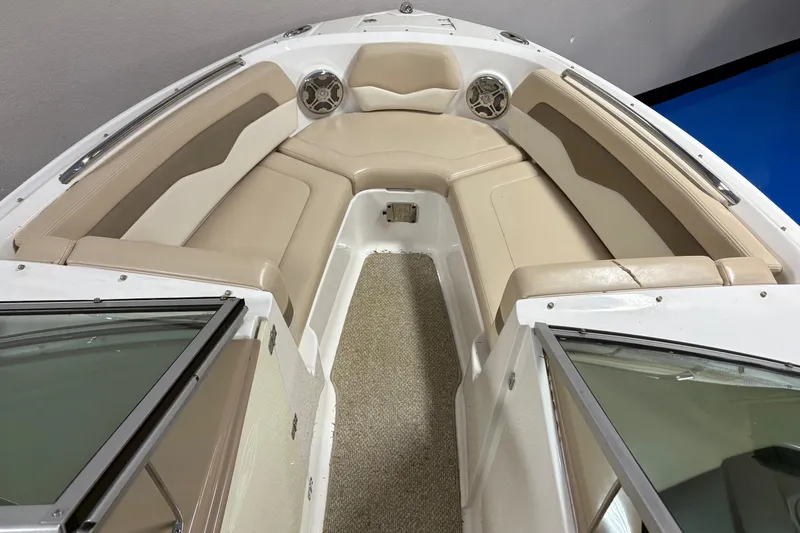 Slide: The Image of Interior view of 2012 Chaparral 226 SSi boat with beige seating and carpeted floor. - 8