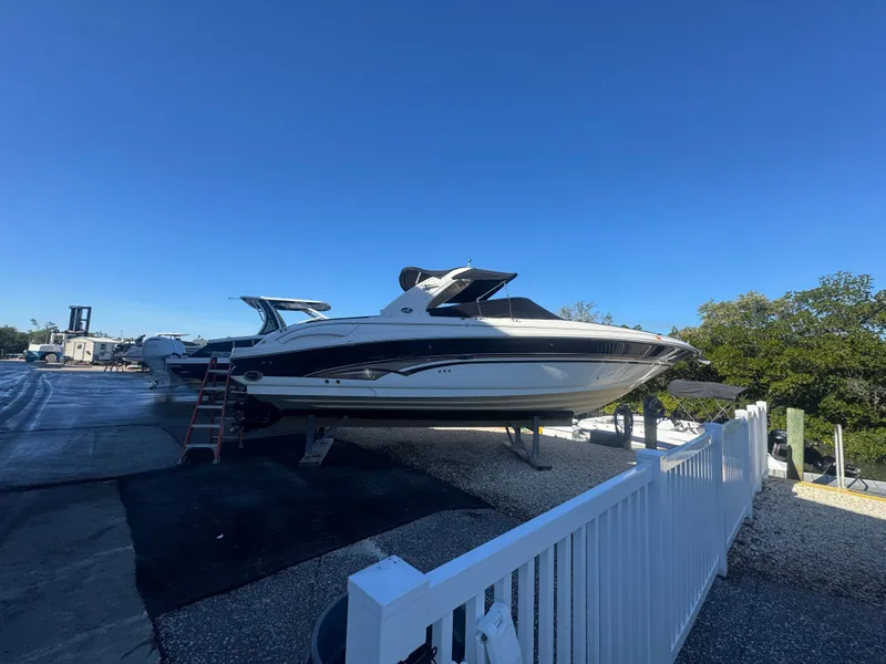 Slide: The Image of 2002 Sea Ray 290 Bowrider on a boatyard. - 2