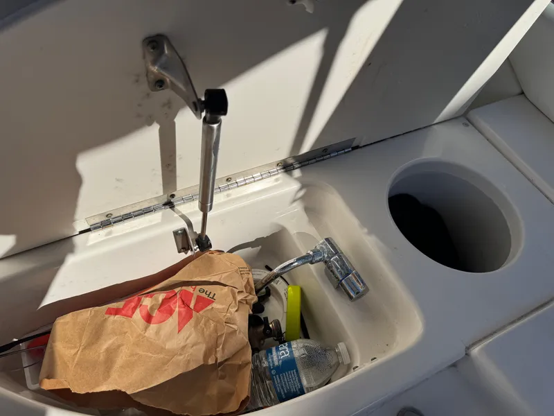 Slide: The Image of Storage compartment in Sea Ray 290 Bowrider boat with bottles and bags. - 21