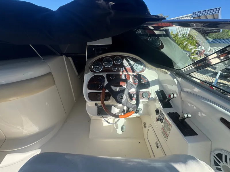 Slide: The Image of Interior view of a 2002 Sea Ray 290 Bowrider cockpit. - 23