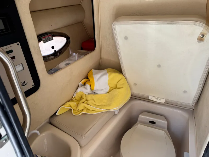 Slide: The Image of Interior of 2002 Sea Ray 290 Bowrider with toilet and towel. - 32