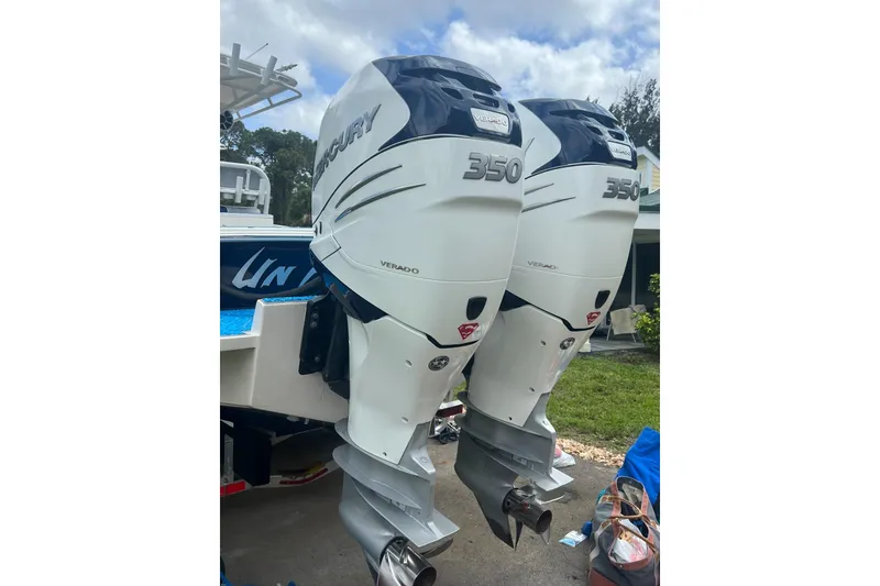 Slide: The Image of Twin Mercury 350 Verado outboard engines on a 2004 Jupiter 31 Cuddy boat. - 10