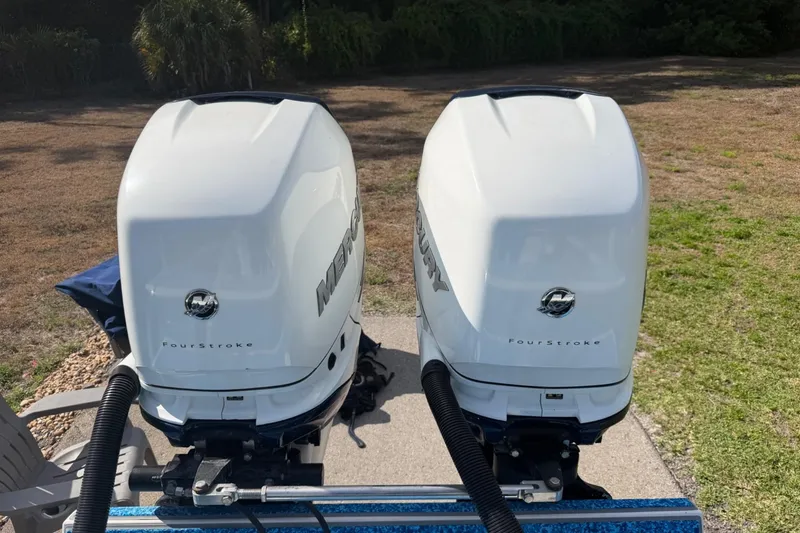Slide: The Image of Twin Mercury FourStroke engines on a 2004 Jupiter 31 Cuddy boat. - 12