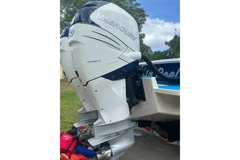 Slide: The Image of 2004 Jupiter 31 Cuddy with Mercury Verado outboard motor, parked outdoors. - 13