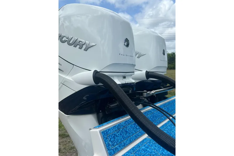 Slide: The Image of Twin Mercury outboard engines on a 2004 Jupiter 31 Cuddy boat. - 14