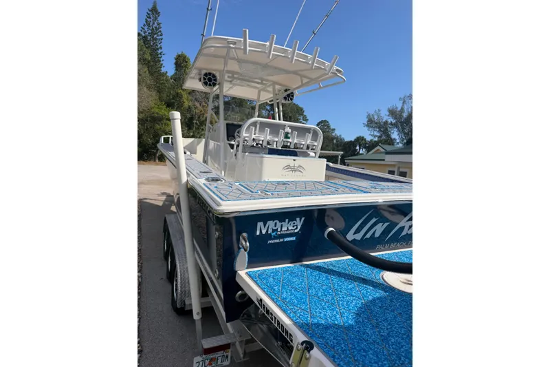 Slide: The Image of 2004 Jupiter 31 Cuddy boat with blue deck, parked on a trailer. - 17