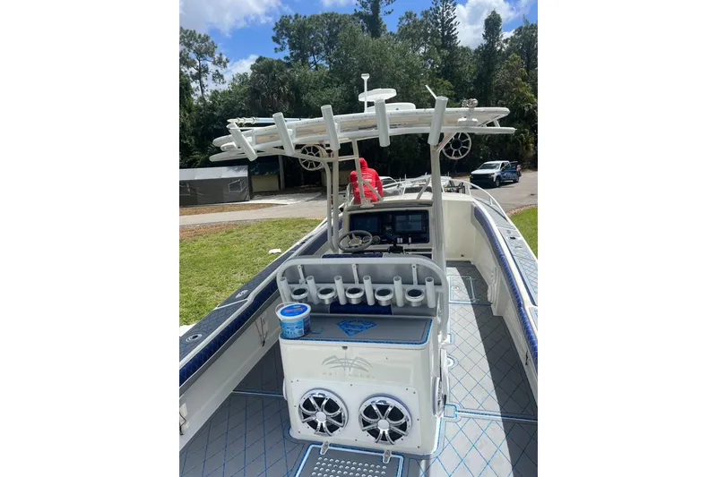 Slide: The Image of 2004 Jupiter 31 Cuddy boat interior with fishing rod holders and navigation equipment. - 21