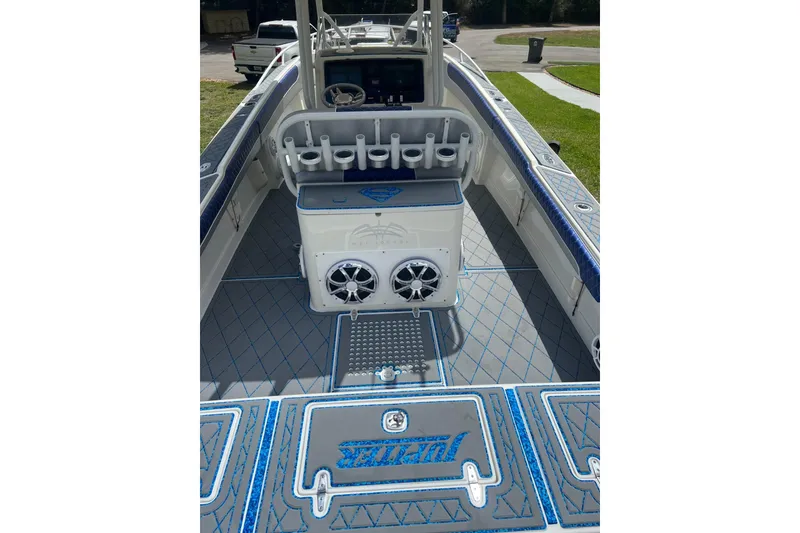 Slide: The Image of 2004 Jupiter 31 Cuddy boat interior with rod holders and custom flooring. - 22