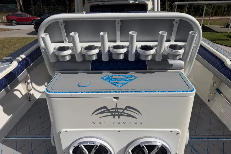 Slide: The Image of 2004 Jupiter 31 Cuddy boat with custom wet sounds audio system and rod holders. - 23