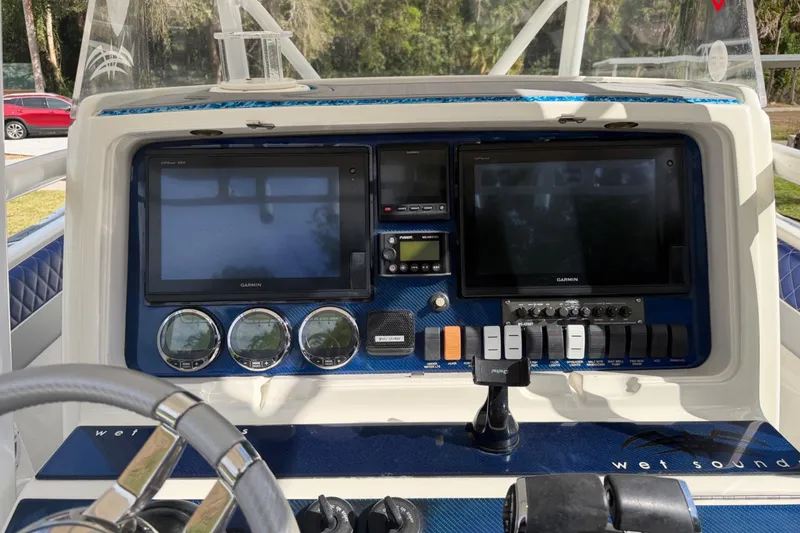Slide: The Image of Control panel of a 2004 Jupiter 31 Cuddy boat with Garmin displays and gauges. - 25