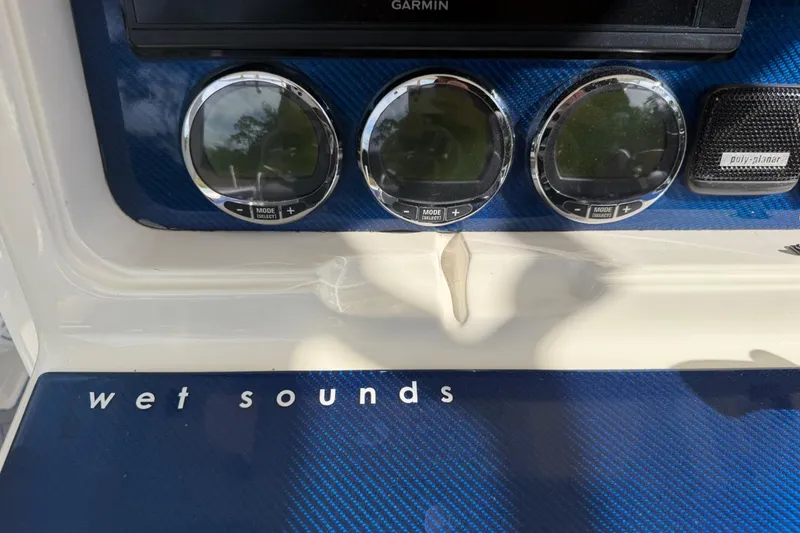 Slide: The Image of Control panel of a 2004 Jupiter 31 Cuddy boat with Wet Sounds audio system. - 26