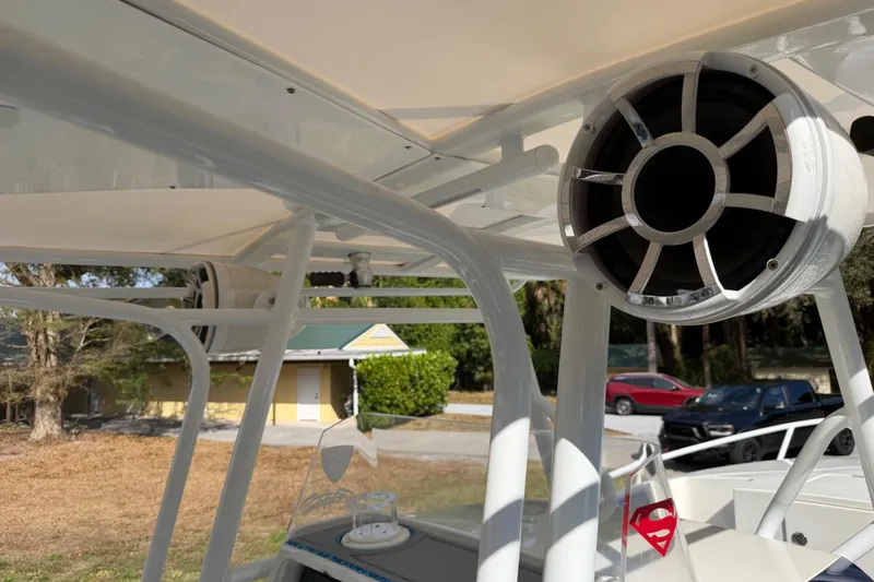 Slide: The Image of 2004 Jupiter 31 Cuddy boat with mounted speaker and outdoor setting. - 27