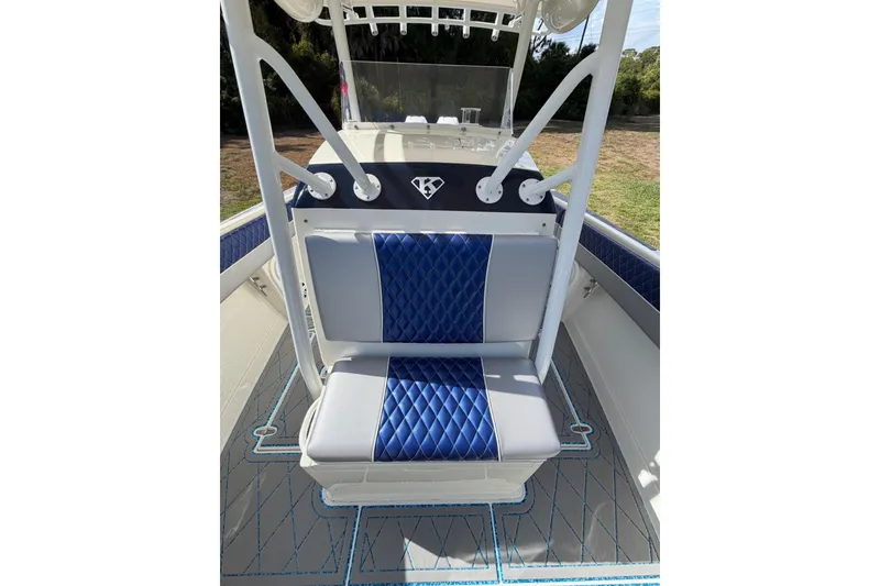Slide: The Image of 2004 Jupiter 31 Cuddy boat interior with blue and gray seating. - 28