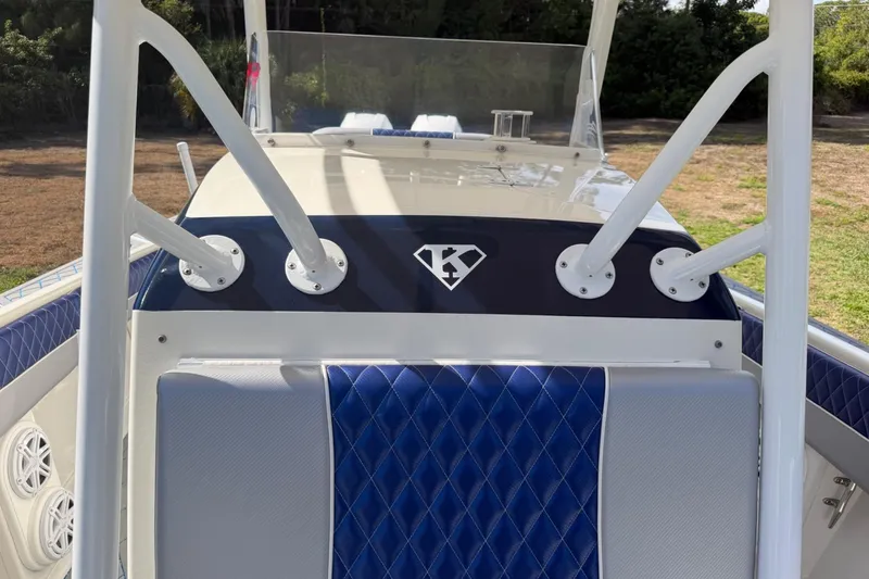 Slide: The Image of 2004 Jupiter 31 Cuddy boat interior with blue diamond-stitched seating and rod holders. - 29
