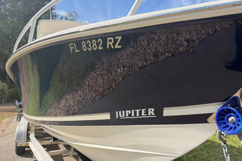 Slide: The Image of 2004 Jupiter 31 Cuddy boat on trailer, displaying registration FL 8382 RZ. - 3