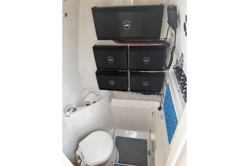 Slide: The Image of 2004 Jupiter 31 Cuddy cabin interior with toilet and storage compartments. - 30