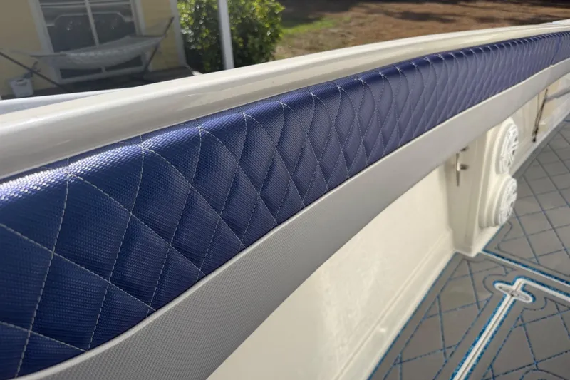 Slide: The Image of Blue quilted upholstery on a 2004 Jupiter 31 Cuddy boat interior. - 31