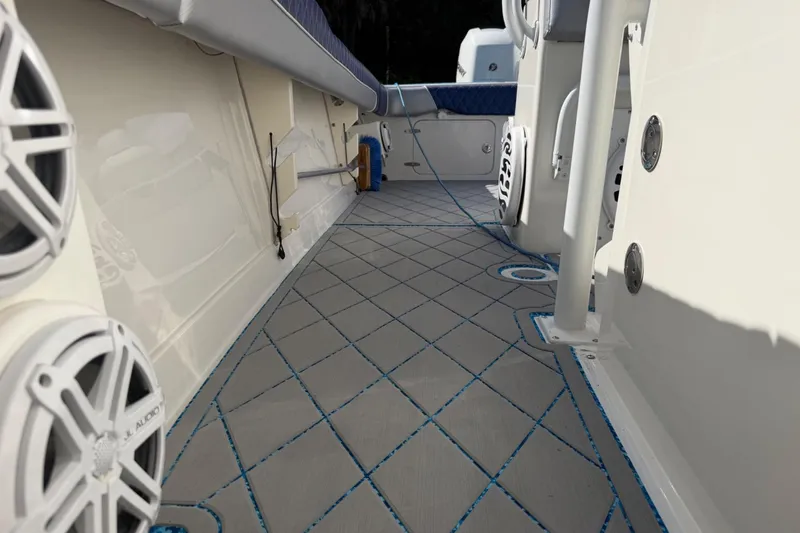 Slide: The Image of 2004 Jupiter 31 Cuddy boat interior with custom flooring and audio speakers. - 36