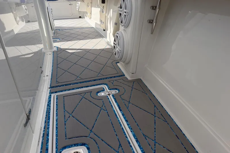 Slide: The Image of 2004 Jupiter 31 Cuddy boat deck with custom non-slip flooring and speaker system. - 39