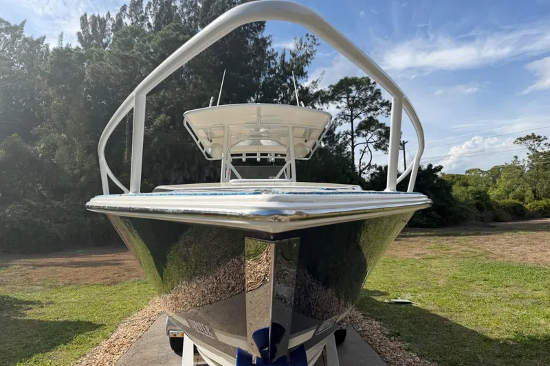 Slide: The Image of 2004 Jupiter 31 Cuddy boat on trailer, surrounded by trees and blue sky. - 4
