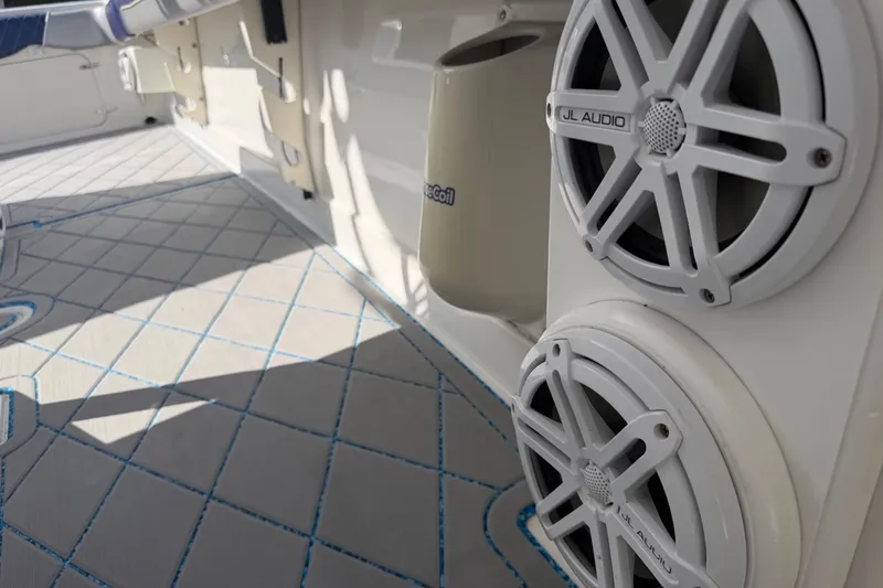 Slide: The Image of 2004 Jupiter 31 Cuddy boat interior with JL Audio speakers and patterned flooring. - 40