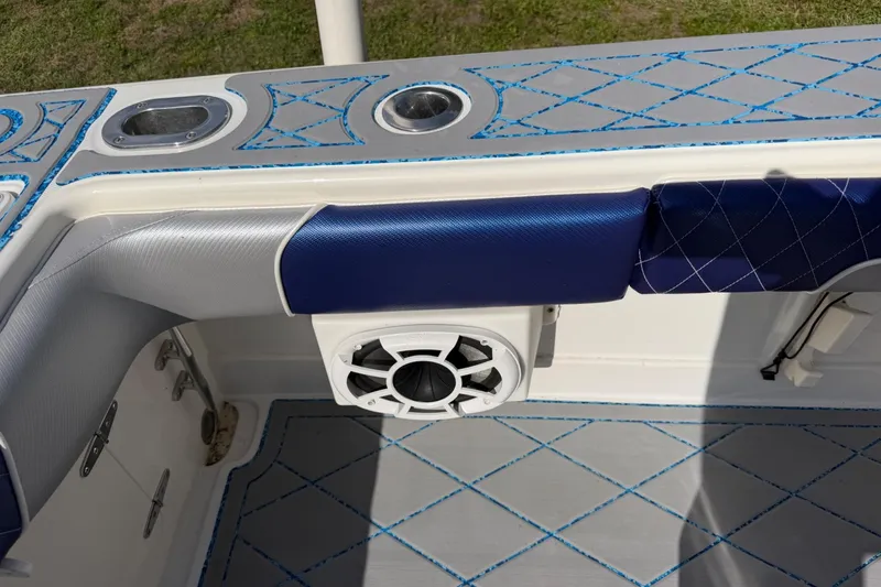 Slide: The Image of 2004 Jupiter 31 Cuddy boat interior with blue and gray cushioned seating and speaker. - 41