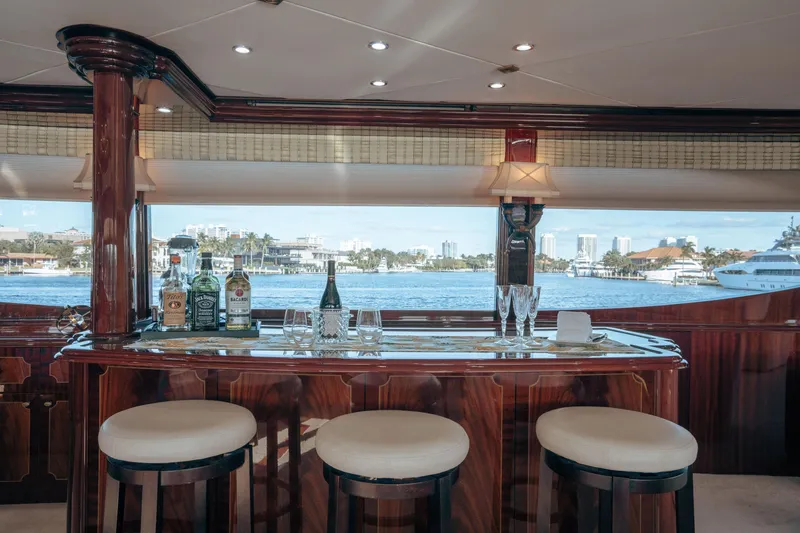 Slide: The Image of Luxurious 2004 Lazzara LY106 yacht interior with elegant bar and scenic waterfront view. - 13