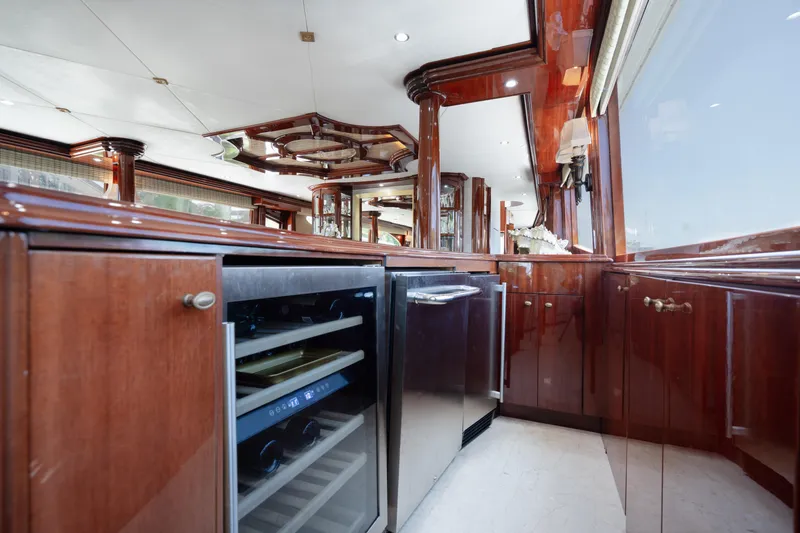 Slide: The Image of Luxurious 2004 Lazzara LY106 yacht interior with elegant wood cabinetry and modern appliances. - 19