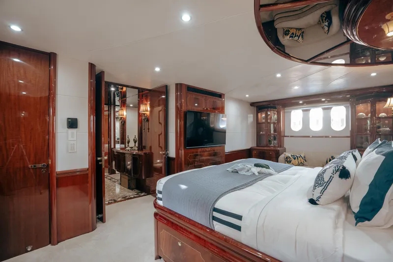 Slide: The Image of Luxurious 2004 Lazzara LY106 yacht bedroom with elegant wood finishes and modern amenities. - 23