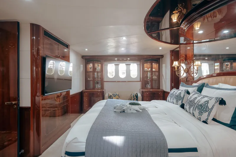 Slide: The Image of Luxurious 2004 Lazzara LY106 yacht bedroom with elegant wood finishes and plush bedding. - 24