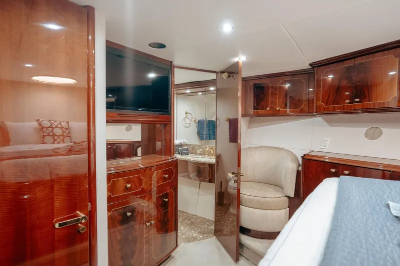 Slide: The Image of Luxurious 2004 Lazzara LY106 yacht interior with elegant wood cabinetry and modern amenities. - 26