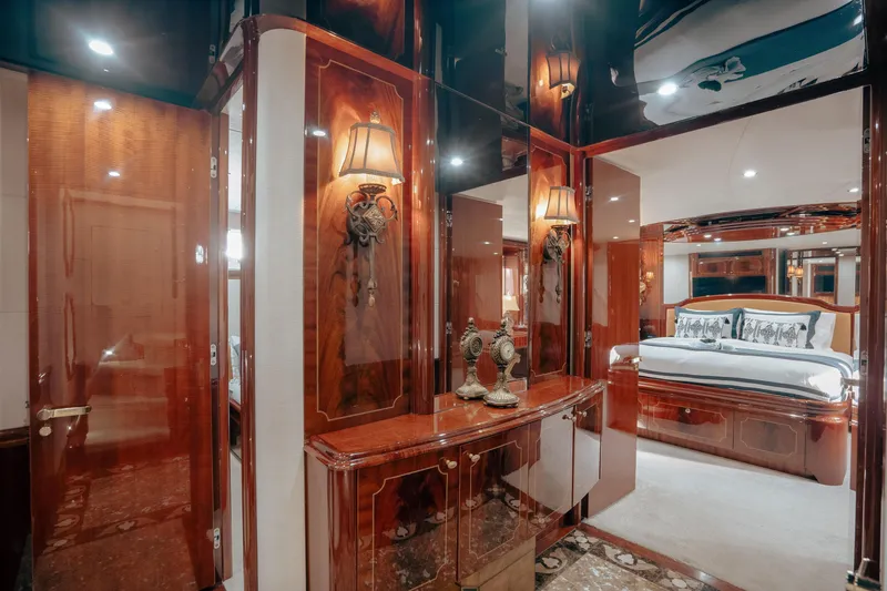 Slide: The Image of Luxurious 2004 Lazzara LY106 yacht interior with elegant wood finishes and plush bedroom. - 30