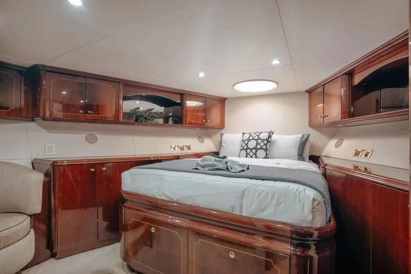 Slide: The Image of Luxurious 2004 Lazzara LY106 yacht bedroom with elegant wood cabinetry and plush bedding. - 32