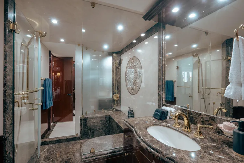Slide: The Image of Luxurious bathroom in 2004 Lazzara LY106 yacht with marble and gold accents. - 34